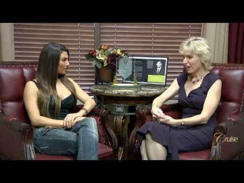Two women conversing in an office setting.