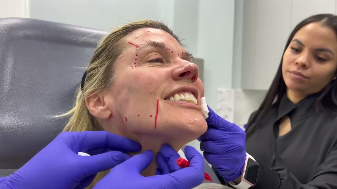 Patient receiving facial treatment in clinic setting.