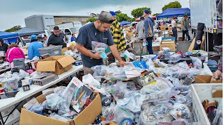 A bunch of dudes collecting video games at the swap meet