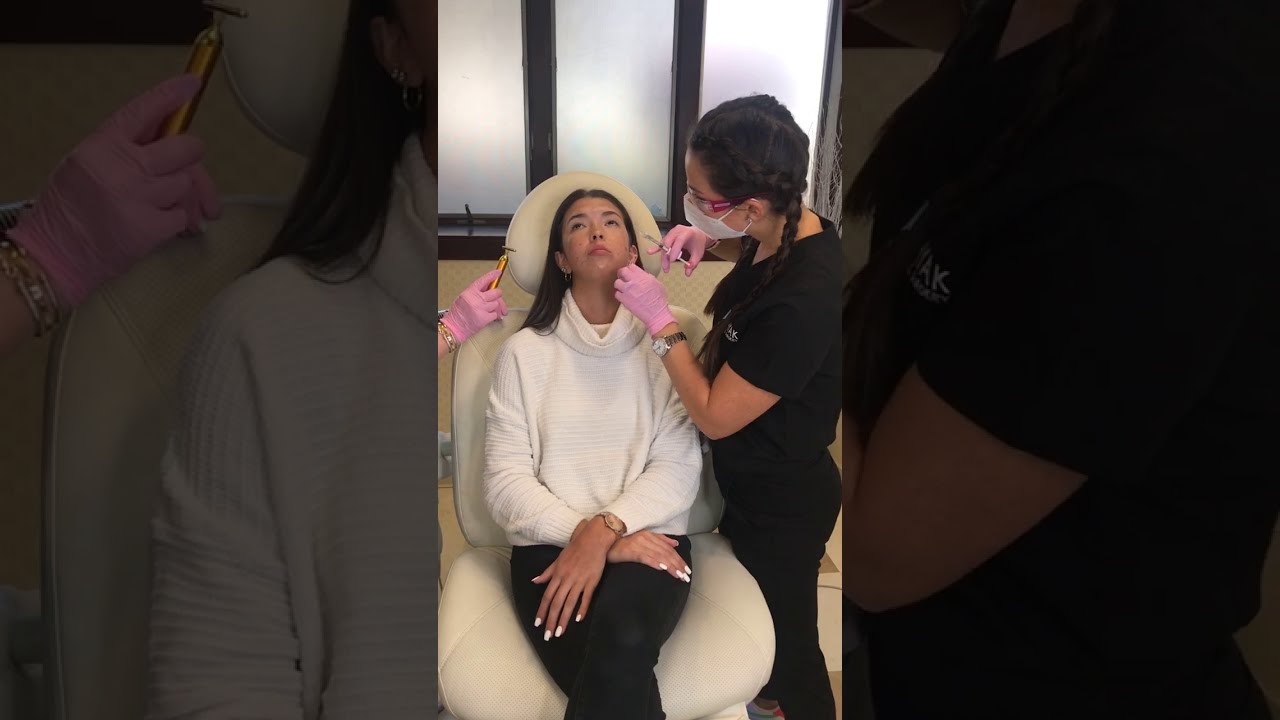 Woman receiving a cosmetic procedure in clinic.
