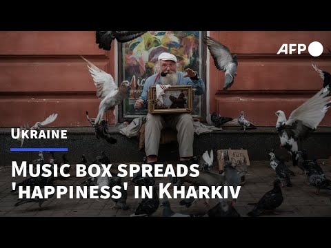 Ukrainian uses hand crank music box to spread 'happiness' in war-torn Kharkiv | AFP