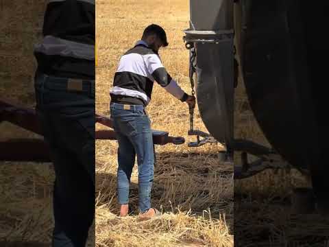 ATTACHING A TRAILER TO A HARVESTING MACHINE