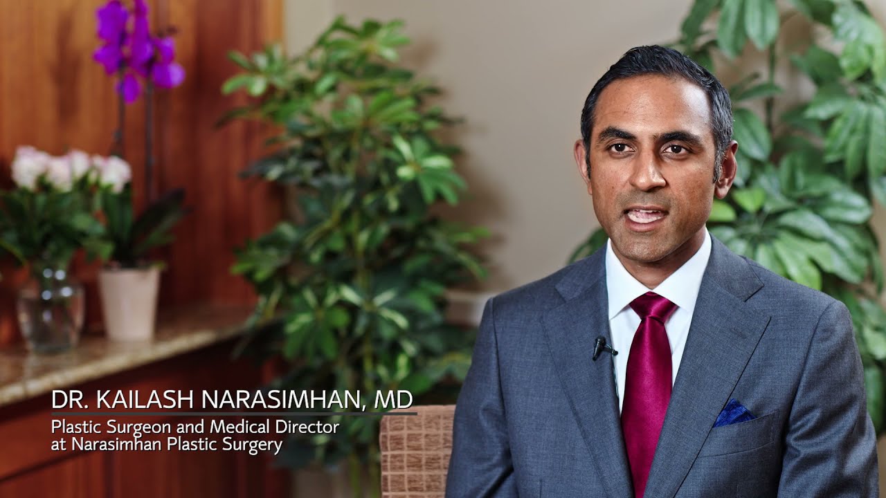 Plastic surgeon speaking in a professional setting.