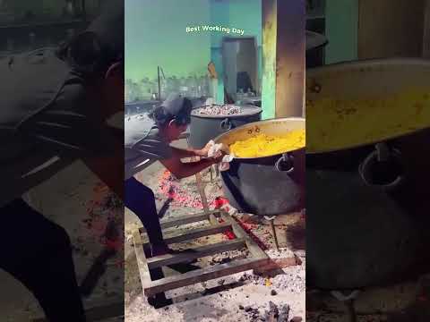 A man uses a makeshift oven mitt to lift a pot of food