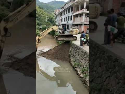 Excavator moving into deep ditch