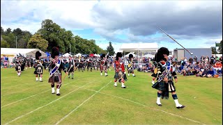 Drum Majors flourish leading massed Pipes and Drums afternoon march at 2024 Aboyne Highland Games