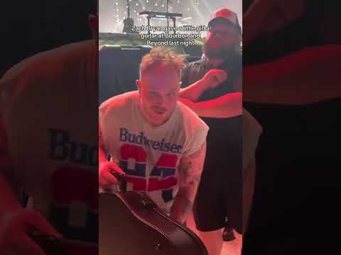Zach Bryan gives his guitar to young fan