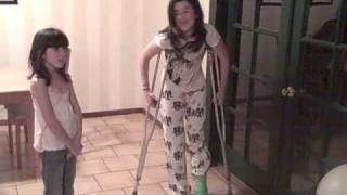 Green long leg cast and crutches