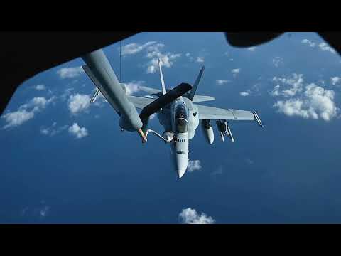 U.S. Marine Corps F/A-18C/D Hornets Aerial refeuling with a U.S. Air Force KC-135 Stratotanker.