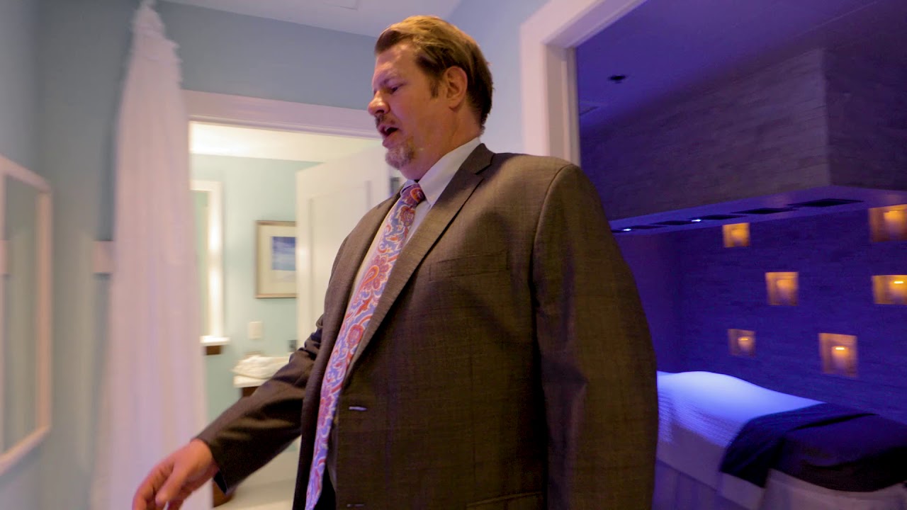 Man in suit exploring a modern room.