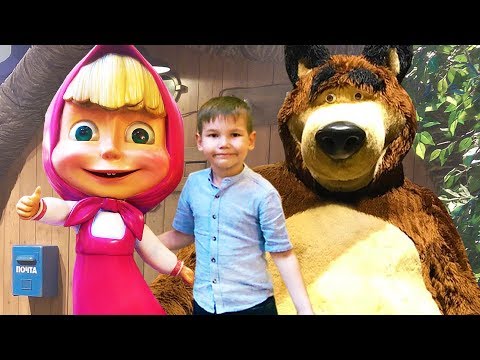 Vlad playing in toy store with big dolls of cartoon characters
