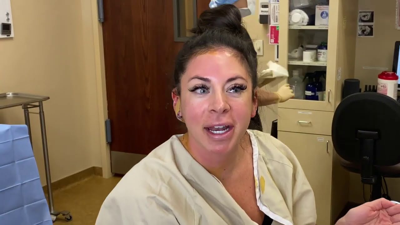 Woman in medical setting with engaging expression