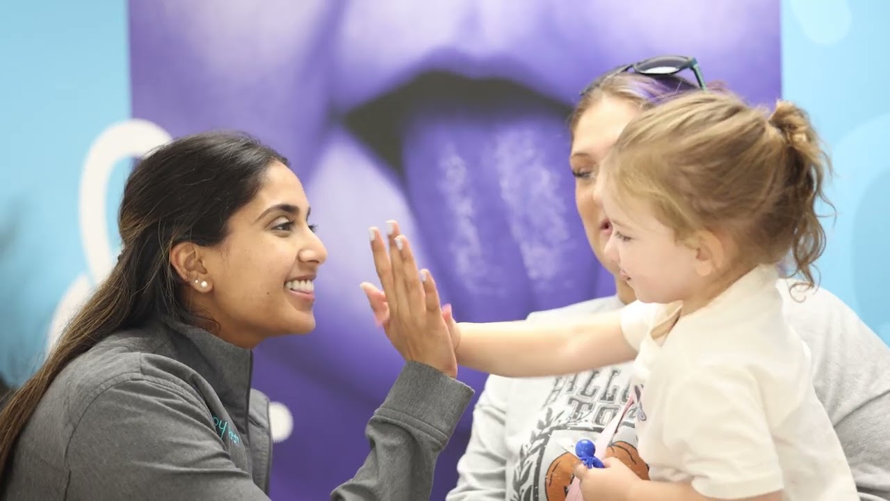 Team member highfiving a child patient