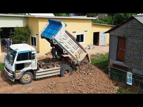 Heavy-Duty Performance: KOMATSU D20P Bulldozer and Trucks Fill Land Efficiently!