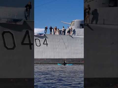 10 year old girl jumping from an old norwegian warship. KNM Narvik