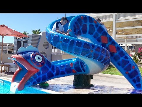 Learn colors with funny kids & water slide in Aqua park outdoor playground. Family fun in real life