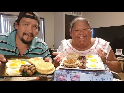 Eating sunny side up eggs/sausages/toast/and waffles/drinking coffee/with my husband