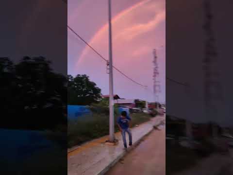 The sky was raining lightly. In front of me was the sun setting, and behind me was a rainbow.#shorts