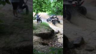 Side By Sides driving through a big mud and water hole at Ride Royal Blue.