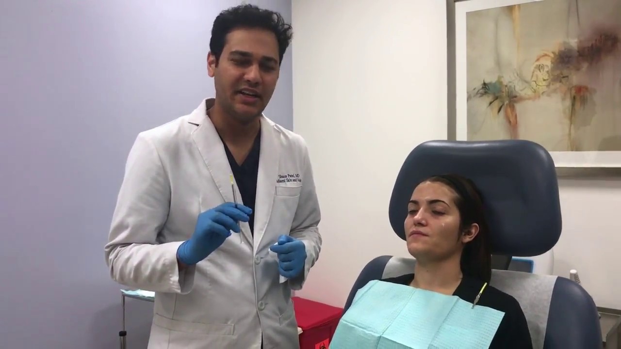 Patient receiving facial treatment in clinic setting.