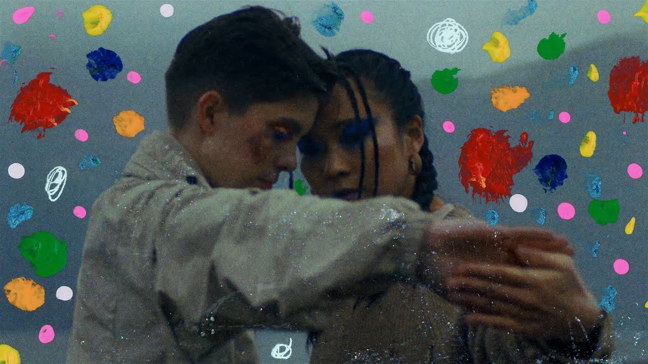 Couple dancing with colorful abstract background.