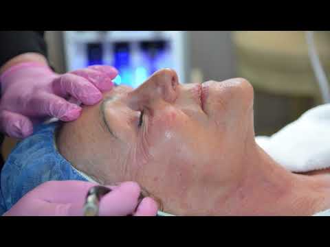Skincare treatment on mature woman's face.