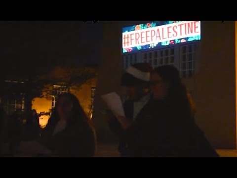 VIDEO STORY: At UNM Hanging of the Greens, students project messages in support of Palestine