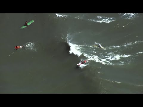 YouTube video thumbnail: Surfers Flock to Florida's Cocoa Beach as Hurricane Erin Churns Offshore