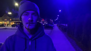 Smoking a Cigarette Under the Purple Hue of a Defective Street Light