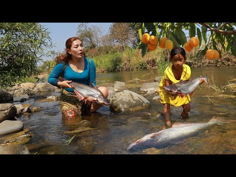 Mother with daughter Pick Marian plum fruit in forest- Roasted big fish with spice eating delicious