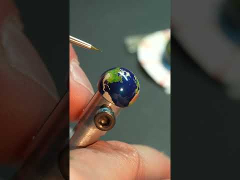 Hand painting a globe for a $570,000 JLC clock