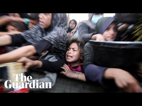 Palestinians scramble for food at soup kitchen in Khan Younis as they await ceasefire