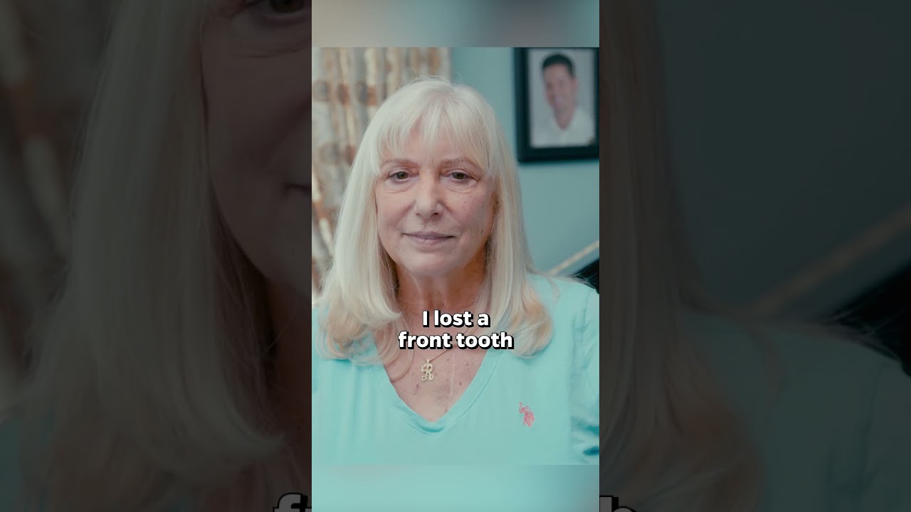 Man in cowboy hat smiling warmly indoors.