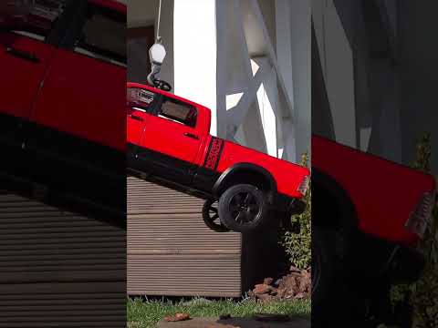 A Truck Crane is lifting a car