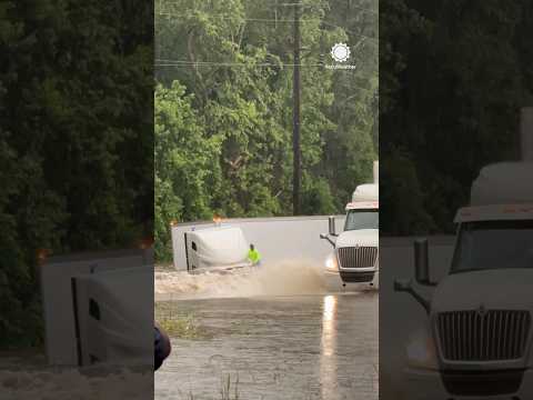 Terrifying Moment as Trucker Drives into Flooded River