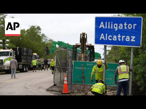 YouTube video thumbnail: Workers Install 'Alligator Alcatraz' Sign for Florida Immigration Detention Center