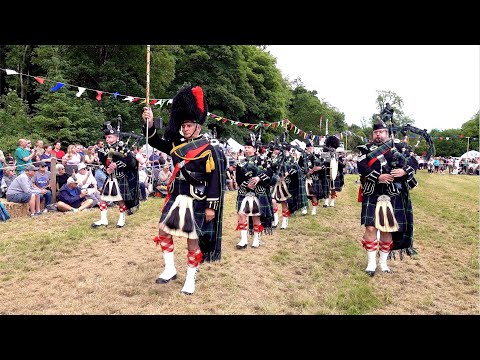 The Lonach Pipe Band march in playing Minstrel Boy during 2024 Drumtochty Highland Games in Scotland