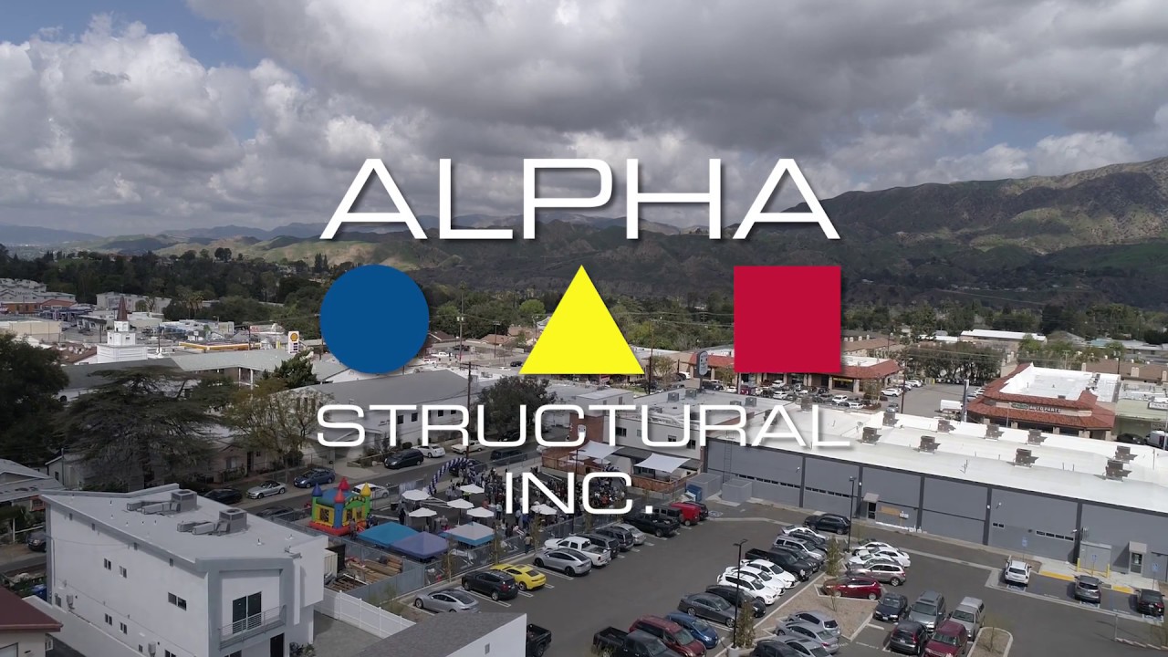 Alpha Structural Inc. logo over urban landscape.
