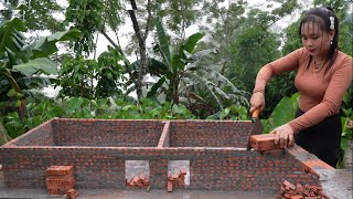 Construction of new pig pen on farm under heavy rain