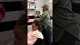 Getting her hair done at the salon