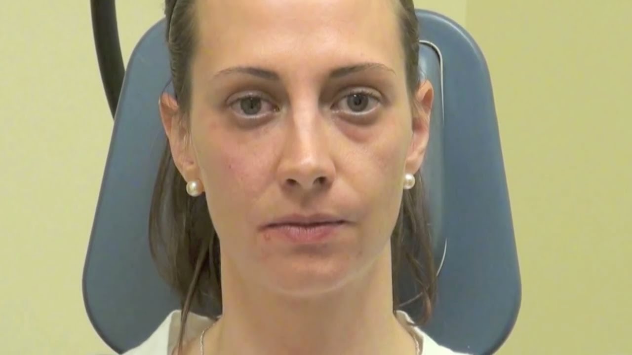 Woman sitting in a medical examination chair.