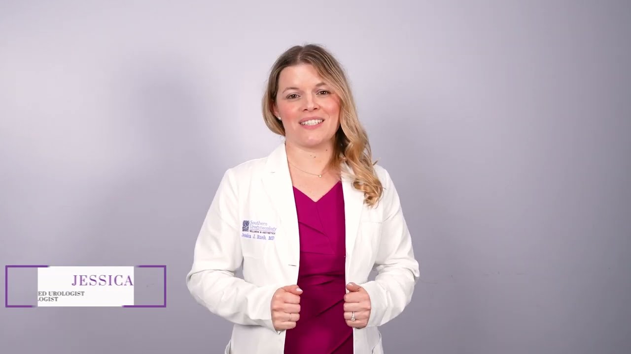Woman smiling while holding a smartphone at desk.