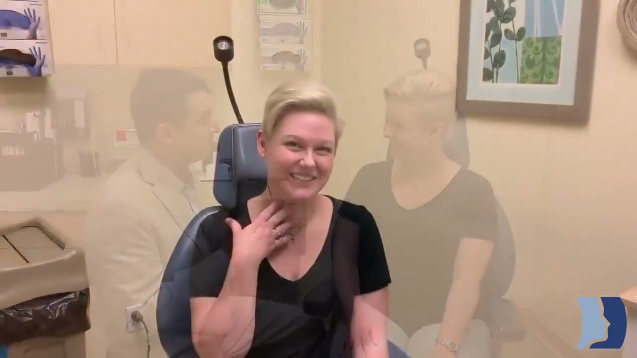 Patient smiling during medical consultation in clinic.