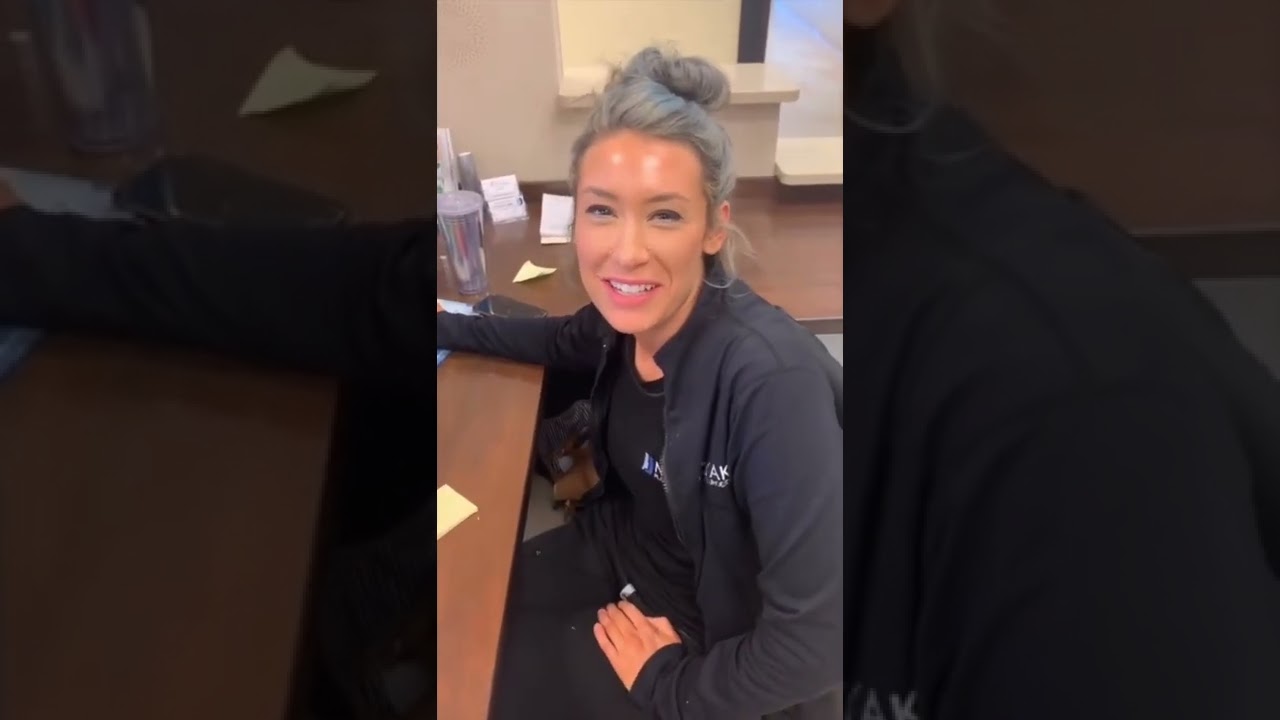 Smiling woman sitting at a table in office.