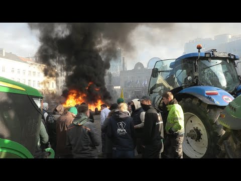 Farmers light fires outside European Parliament building in Brussels | AFP