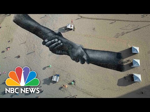 Artist Creates Giant Symbol Of Togetherness On Rio’s Copacabana Beach