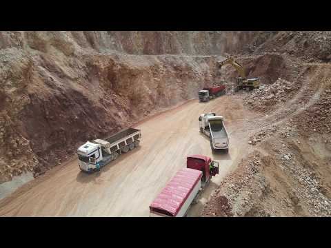 Drone View: Caterpillar 375 Excavator Loading Blasted Rock Αt A Busy Quarry - Sotiriadis/Labrianidis