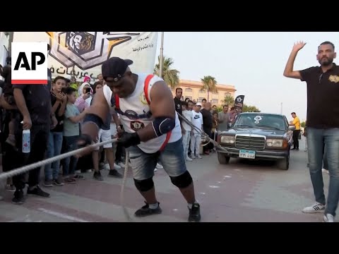 YouTube video thumbnail: Egyptian Wrestler Attempts Guinness Record for Most Cars Pulled by a Person
