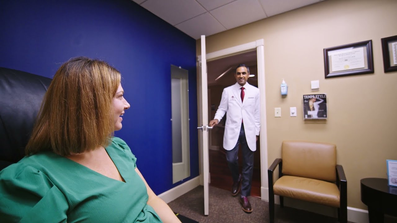 Doctor entering consultation room with patient.