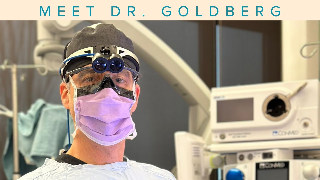 Surgeon wearing protective gear in operating room.